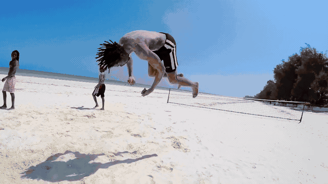 Waves rolling onto the Kenyan coast with people enjoying the beach